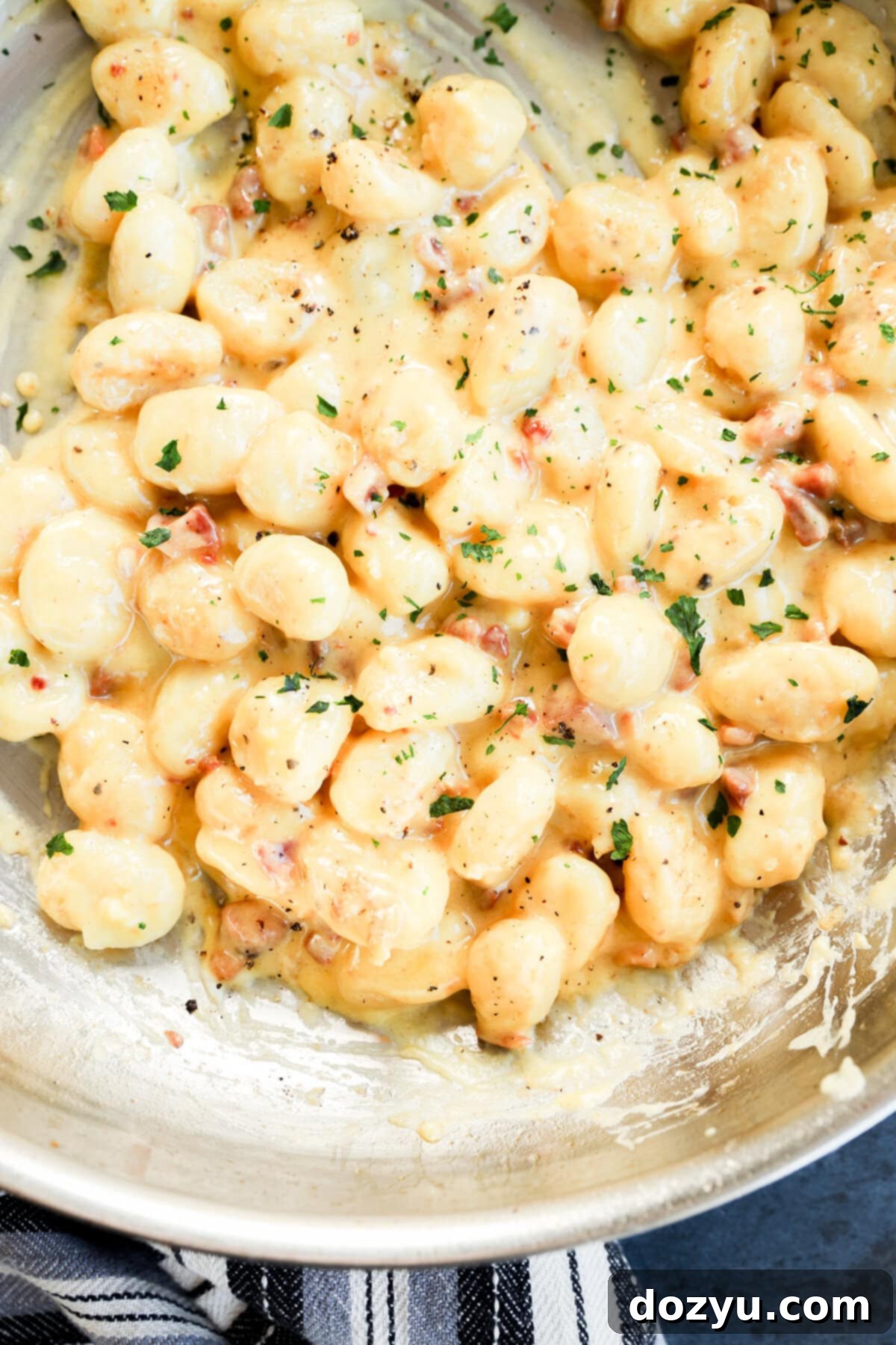 Gnocchi carbonara in a skillet cooking