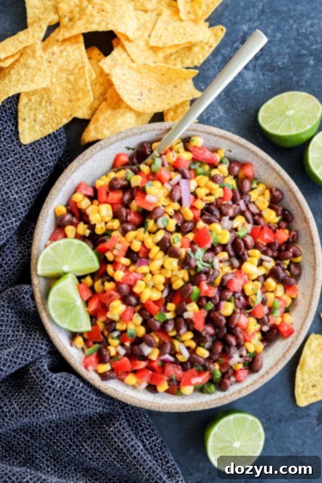 Southwestern Black Bean Corn Salsa Dip 8 Bowl of fresh vegetables to make an appetizer with chips around and fresh limes