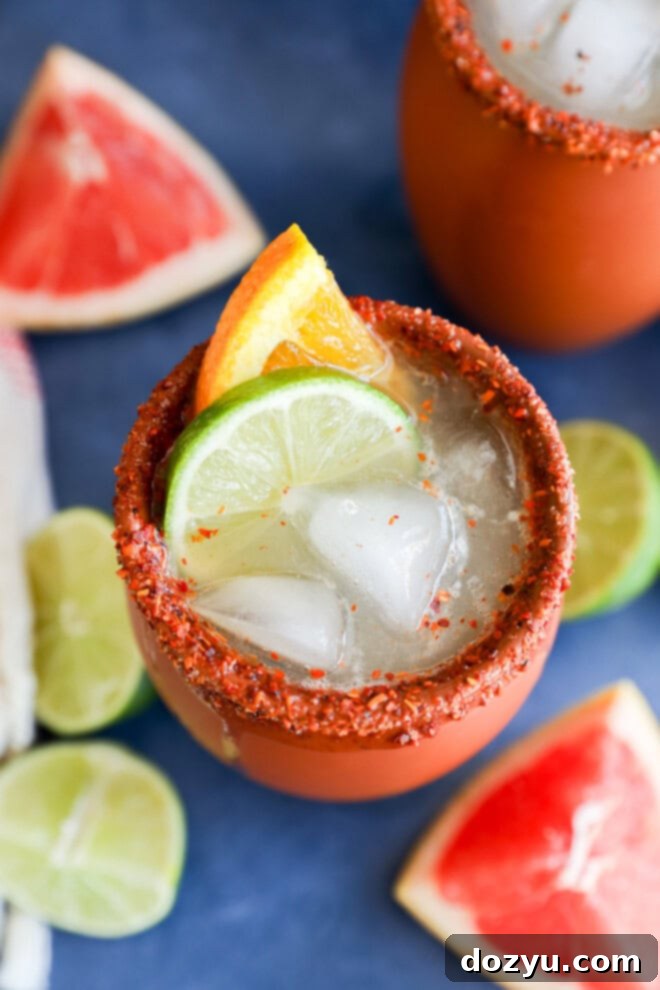 Fresh citrus garnish on clay cup with fresh cocktail in it