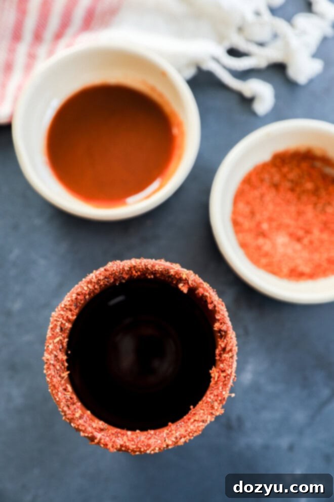 clay cup rimmed with chamoy and tajin seasoning