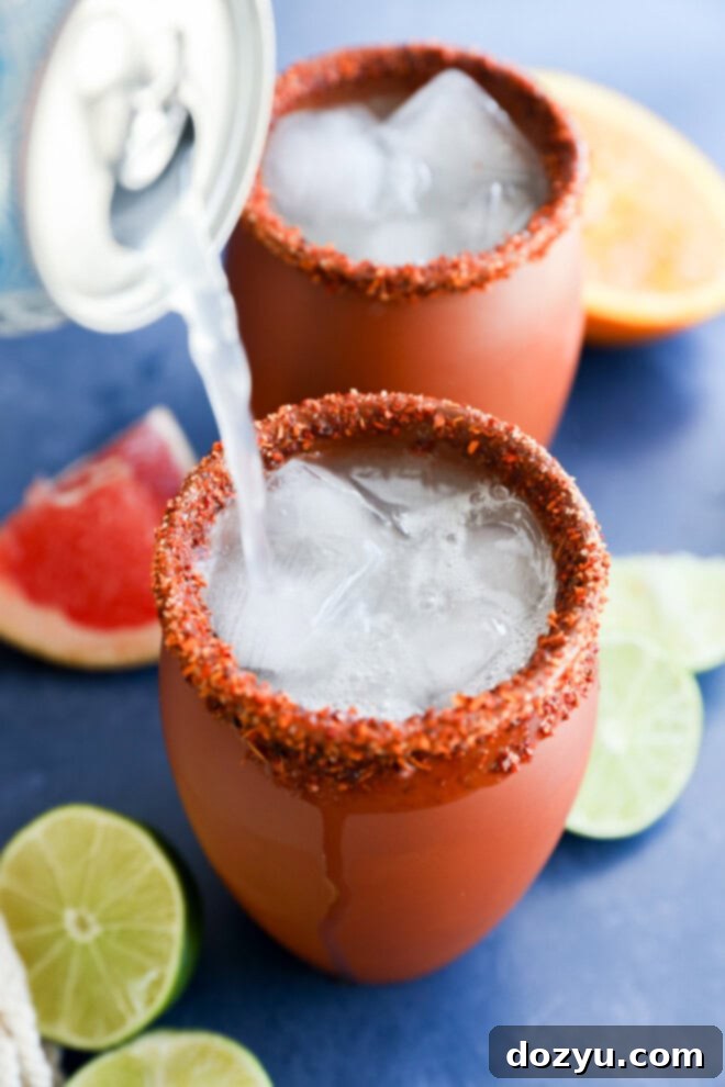 pouring grapefruit soda into the clay cup for a cocktail