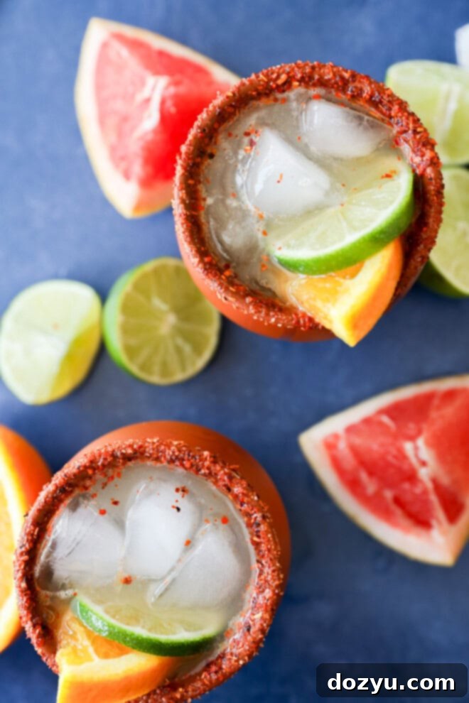 Cantarito cocktails in clay cups with fresh citrus all around