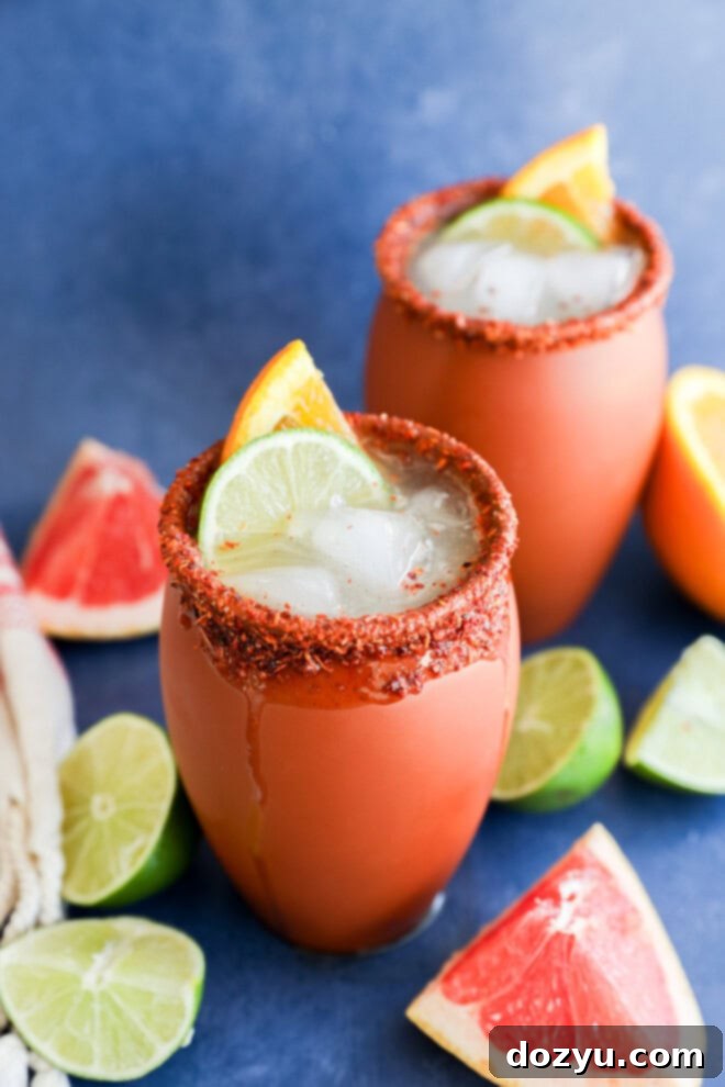 Easy Mexican citrusy cocktail in clay cups with fresh citrus