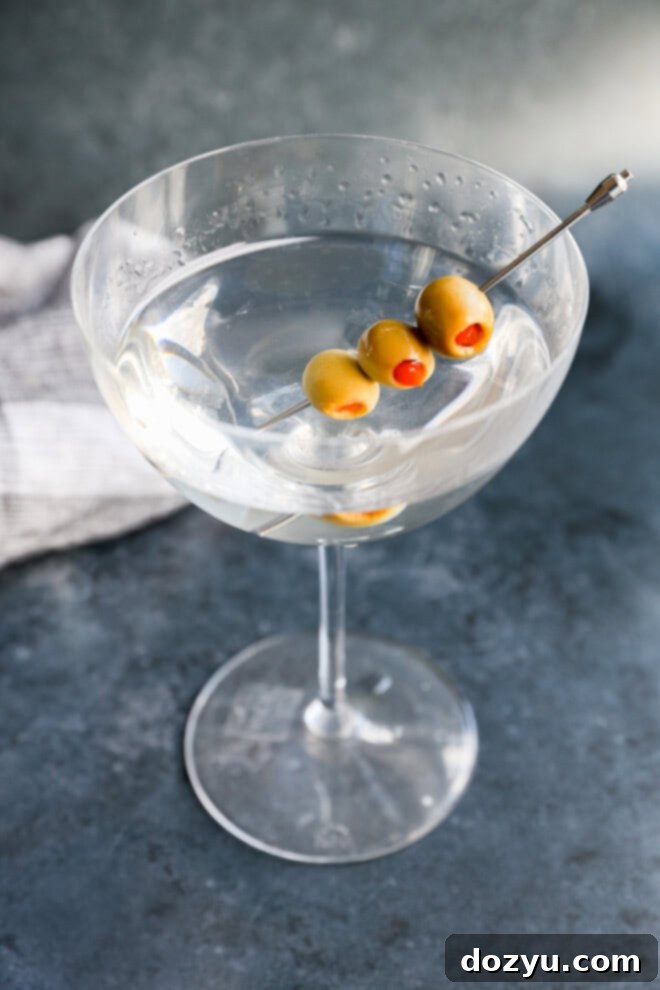 Classic Gin Martini 2 Garnished with olives gin martini in a coupe glass