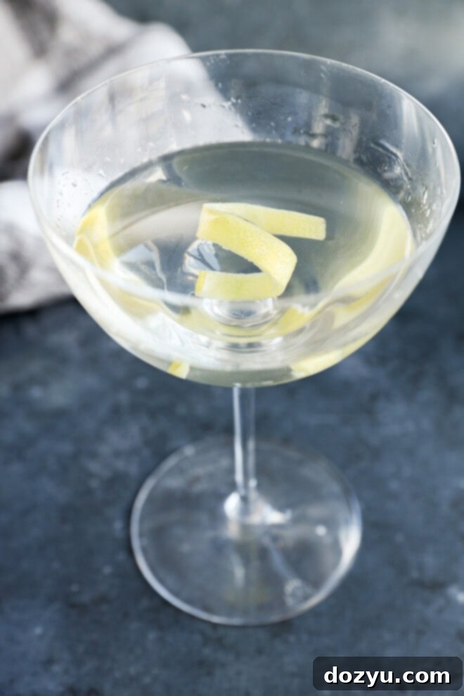 Classic Gin Martini 3 gin martini with a lemon twist garnish in coupe glass