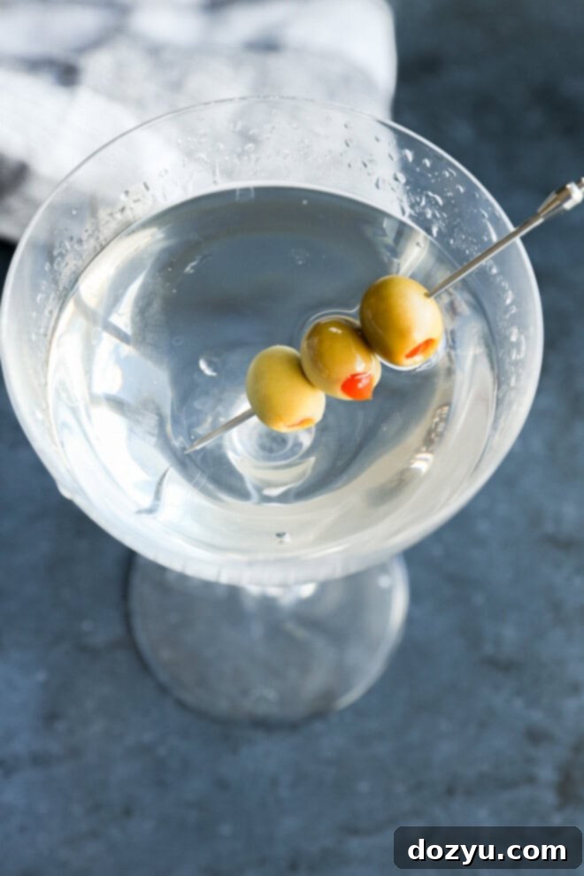Classic Gin Martini 6 easy cocktail in coupe glass with olives garnish