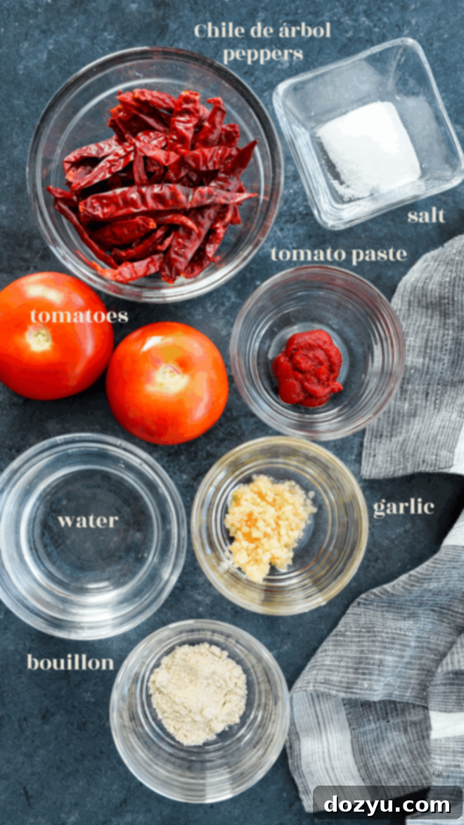 Individual bowls containing dried chile de árbol peppers, tomato paste, plum tomatoes, garlic cloves, and a bouillon cube, labeled clearly as ingredients for salsa.