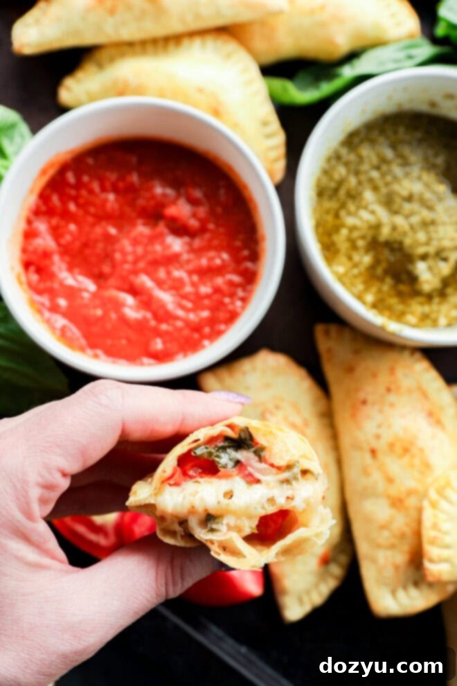caprese empanada in half in hand