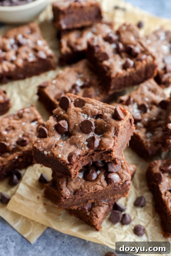 easy decadent dessert squares piled up on brown parchment paper