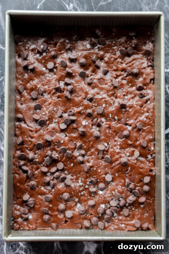 chocolate chocolate chip cookie bars in baking pan before baking