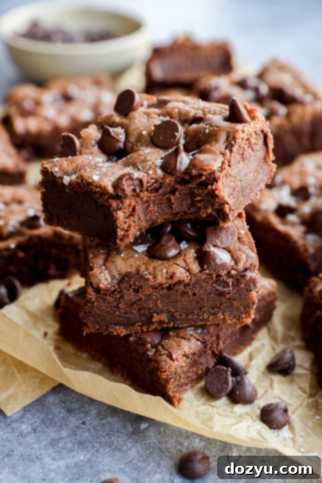 bite take out of a chocolate chocolate chip cookie bar in a stack