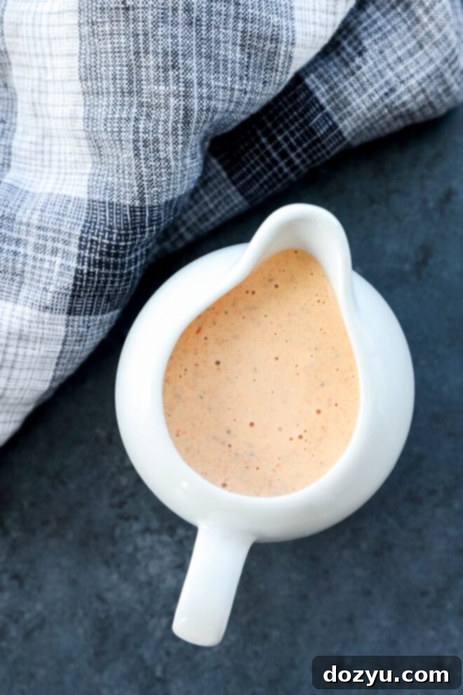 chipotle ranch salad dressing in a pouring vessel that is white and with linen