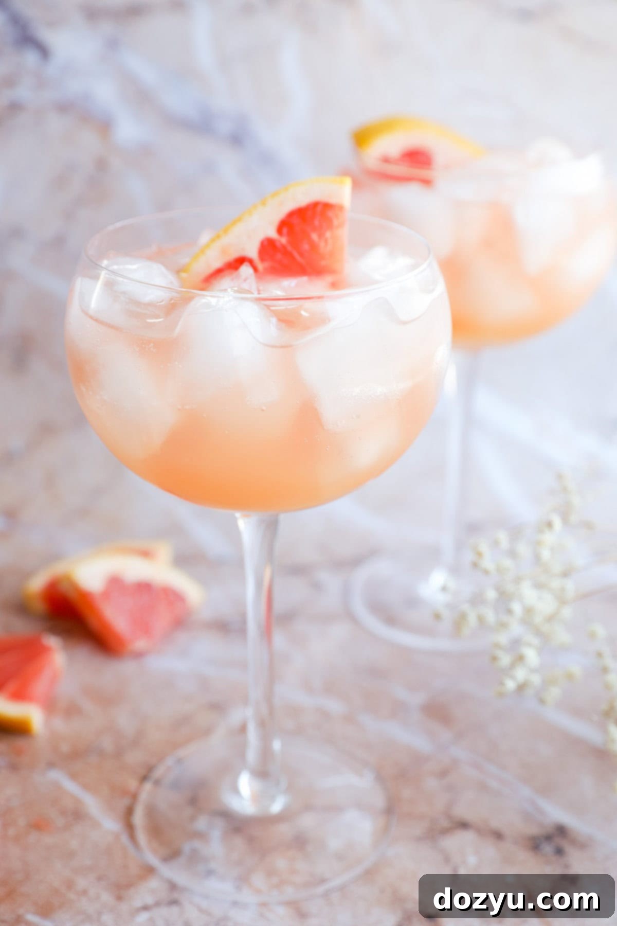 grapefruit vodka elderflower liqueur cocktail in stemmed wine glasses