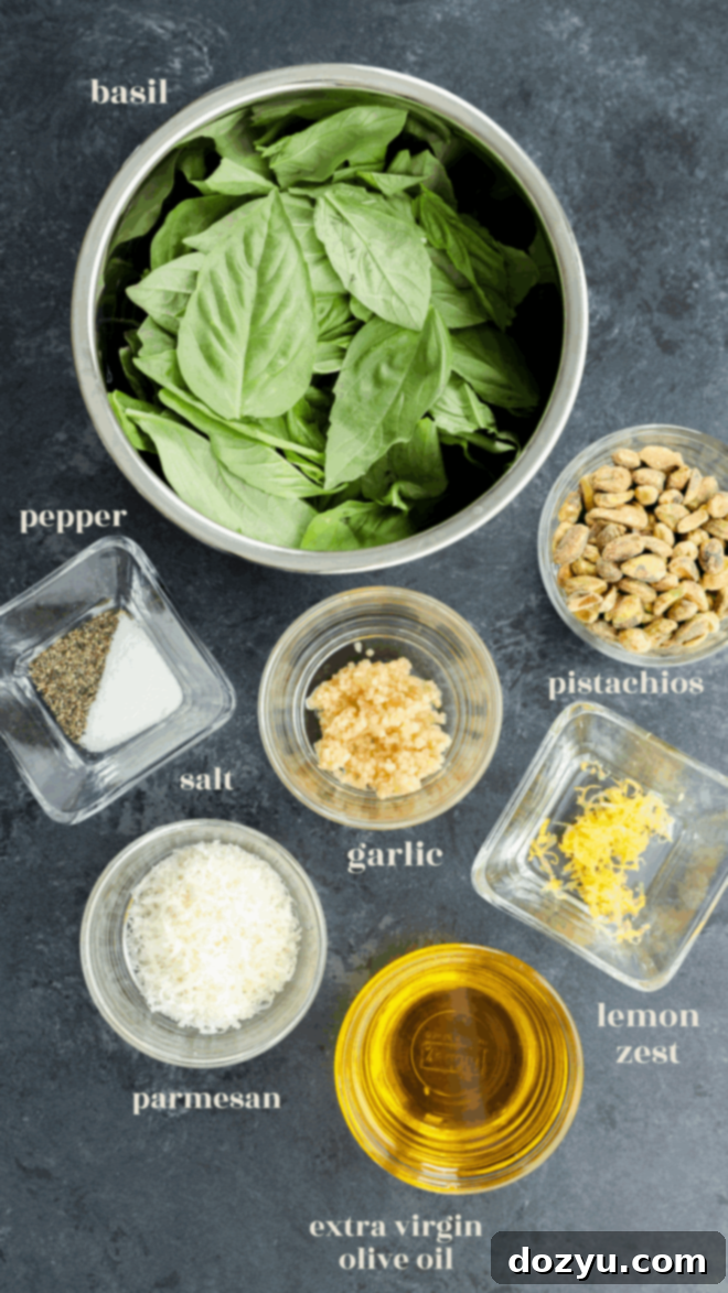 Vibrant Pistachio Pesto 3 Various ingredients for pistachio pesto displayed in small bowls with text labels: pistachios, fresh basil, garlic, Parmesan, lemon zest, olive oil, and salt and pepper.