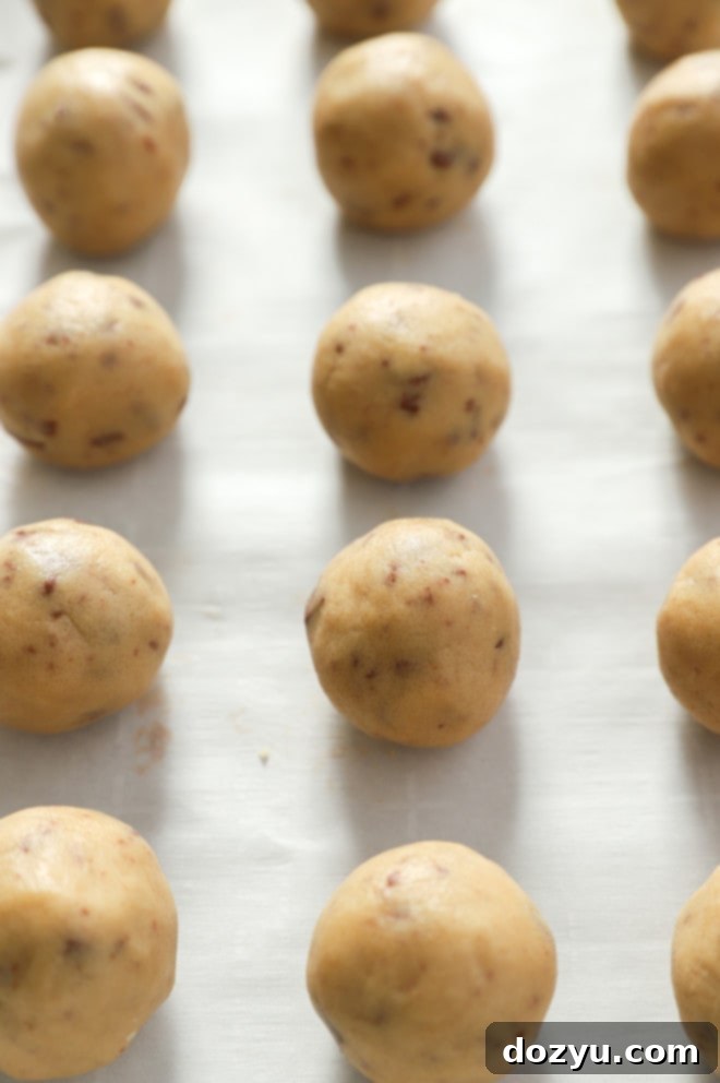 Effortless No-Bake Cookie Dough Treats 6 chocolate chip cookie dough bites on parchment paper image