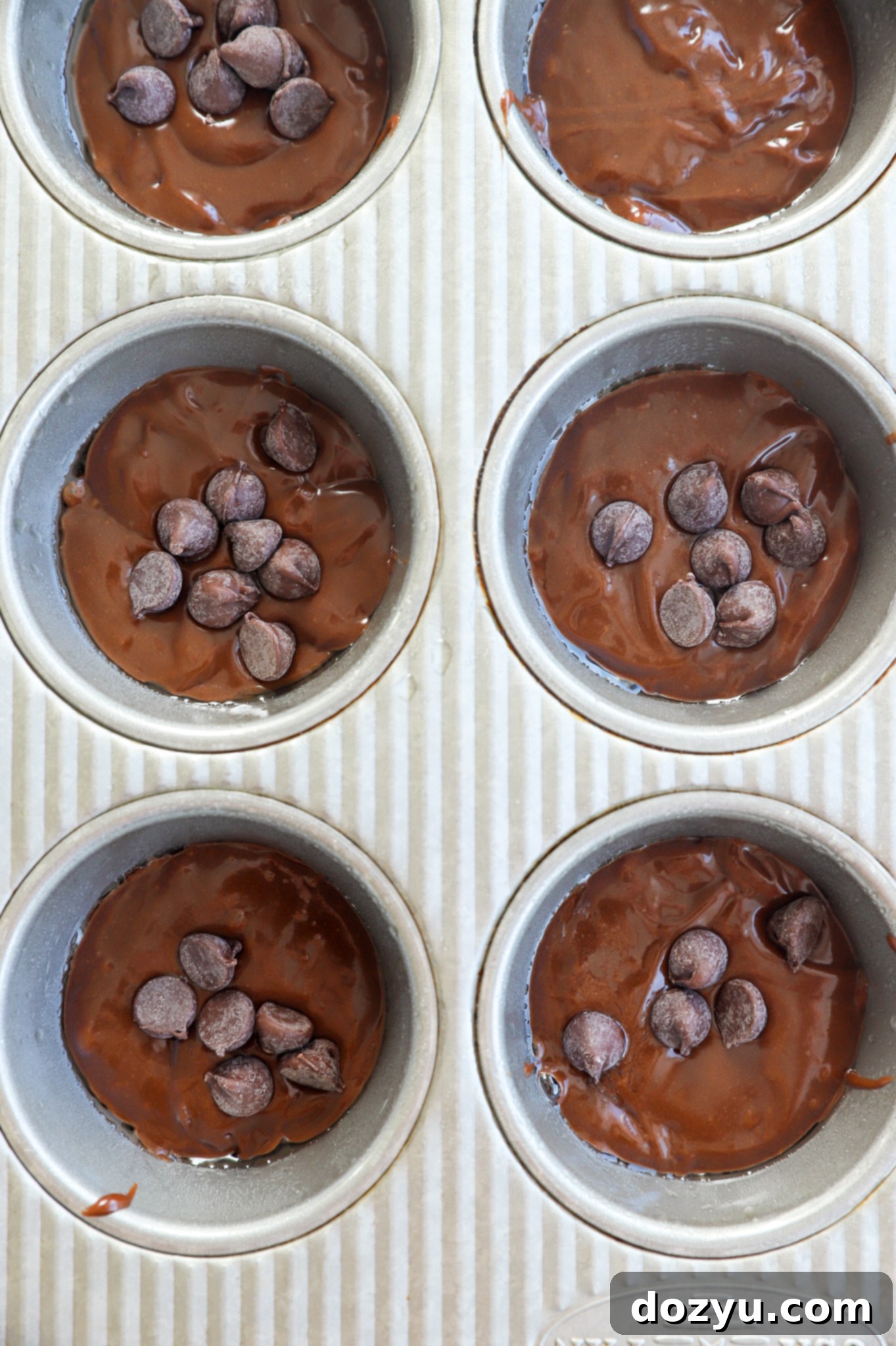 Overhead image of cake batter in muffin tins before baking