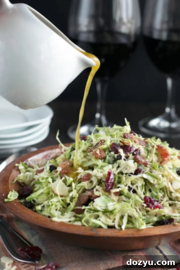 A healthy and delicious Bacon Cranberry Shaved Brussels Sprouts Salad, perfect as a Thanksgiving side dish, showcasing the vibrant combination of crisp Brussels sprouts, savory bacon, and tart cranberries.