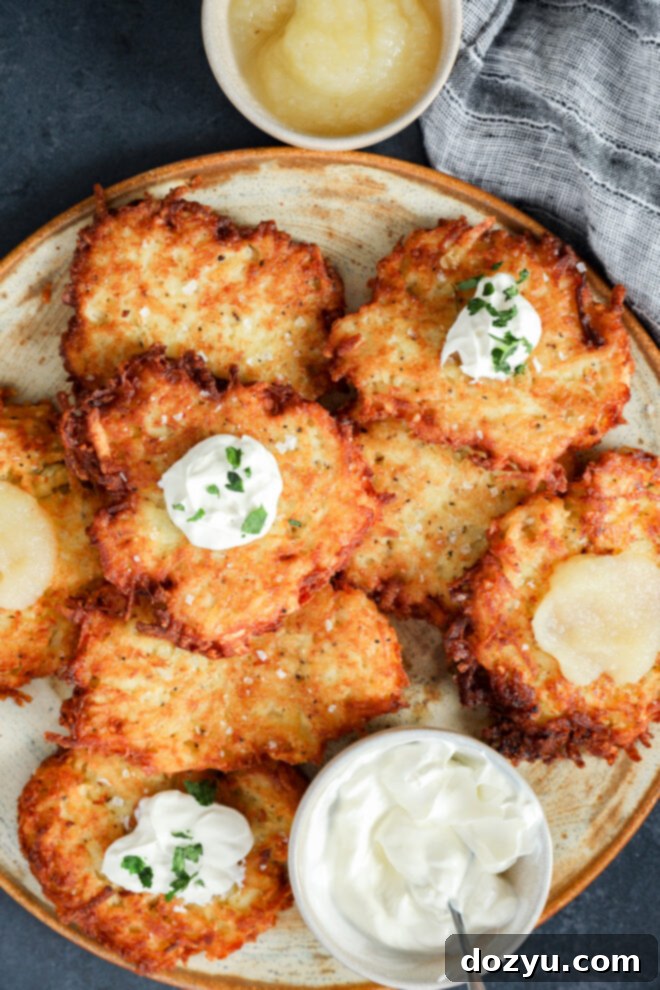 Crispy Jewish latkes with sour cream, chives, and applesauce.